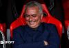 Jose Mourinho smiles and folds his arms