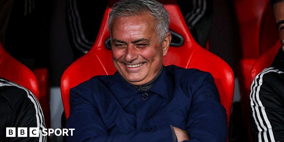 Jose Mourinho smiles and folds his arms