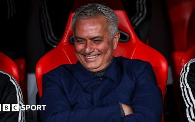 Jose Mourinho smiles and folds his arms