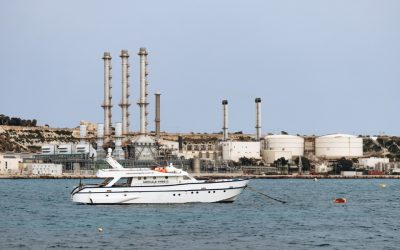 yacht-on-water-near-industrial-refinery-coastal-facility.jpg - ReactMedia