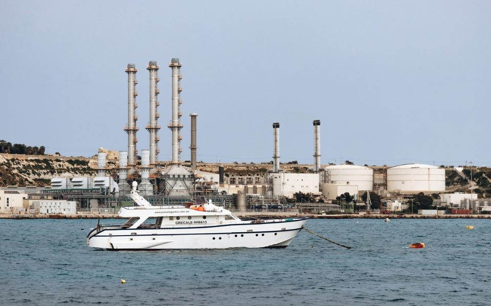 yacht-on-water-near-industrial-refinery-coastal-facility.jpg - ReactMedia
